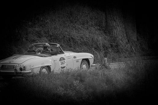 CAGLI , ITALY - OTT 24 - 2020 : MERCEDES-BENZ 190 SL 1956 on an old racing car in rally Mille Miglia 2020 the famous italian historical race (1927-1957