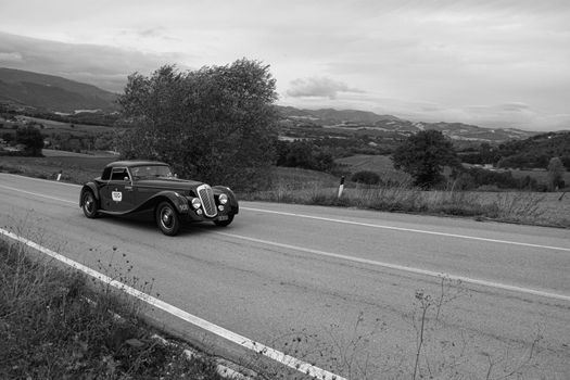 CAGLI , ITALY - OTT 24 - 2020 : LANCIA ASTURA 1938 on an old racing car in rally Mille Miglia 2020 the famous italian historical race (1927-1957