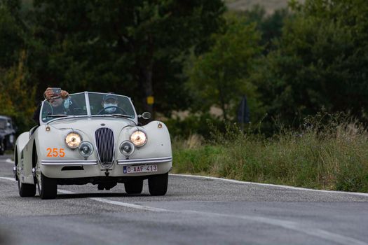 CAGLI , ITALY - OTT 24 - 2020 : JAGUAR XK 120 SE OTS 1954 on an old racing car in rally Mille Miglia 2020 the famous italian historical race (1927-1957