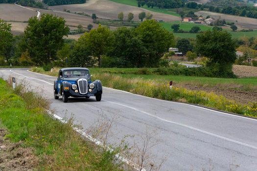 CAGLI , ITALY - OTT 24 - 2020 : LANCIA ASTURA 1938 on an old racing car in rally Mille Miglia 2020 the famous italian historical race (1927-1957