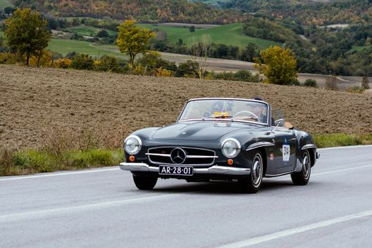 CAGLI , ITALY - OTT 24 - 2020 : MERCEDES-BENZ 190 SL 1955 on an old racing car in rally Mille Miglia 2020 the famous italian historical race (1927-1957