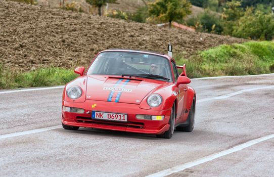 CAGLI , ITALY - OTT 24 - 2020 : PRSCHE CARRERA LIVREA MARTINI on an old racing car in rally Mille Miglia 2020 the famous italian historical race (1927-1957)