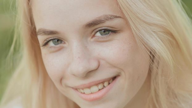 Close-up face of a smiling 19 year old blonde girl