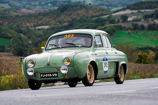 CAGLI , ITALY - OTT 24 - 2020 : RENAULT DAUPHINE 1957 on an old racing car in rally Mille Miglia 2020 the famous italian historical race (1927-1957