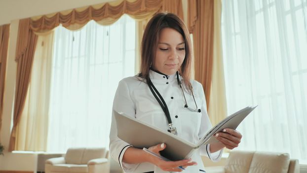 girl doctor walking in hospital with documents.