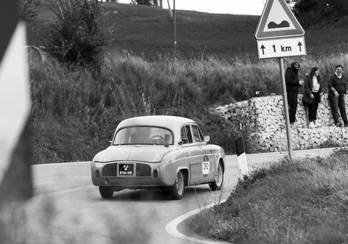 CAGLI , ITALY - OTT 24 - 2020 : RENAULT DAUPHINE 1957 on an old racing car in rally Mille Miglia 2020 the famous italian historical race (1927-1957