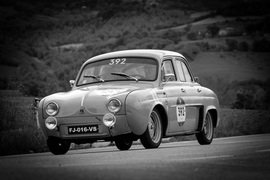 CAGLI , ITALY - OTT 24 - 2020 : RENAULT DAUPHINE 1957 on an old racing car in rally Mille Miglia 2020 the famous italian historical race (1927-1957