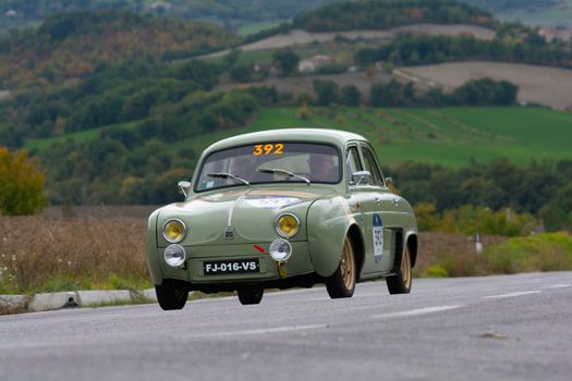 CAGLI , ITALY - OTT 24 - 2020 : RENAULT DAUPHINE 1957 on an old racing car in rally Mille Miglia 2020 the famous italian historical race (1927-1957