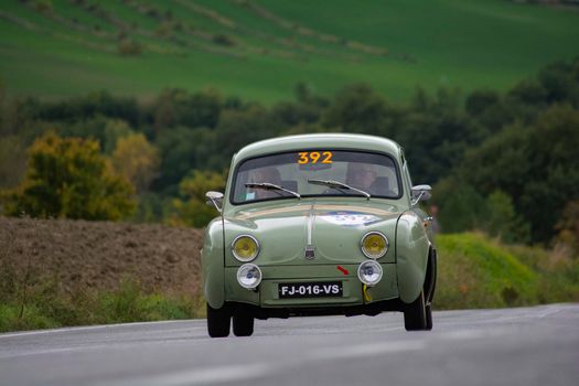 CAGLI , ITALY - OTT 24 - 2020 : RENAULT DAUPHINE 1957 on an old racing car in rally Mille Miglia 2020 the famous italian historical race (1927-1957