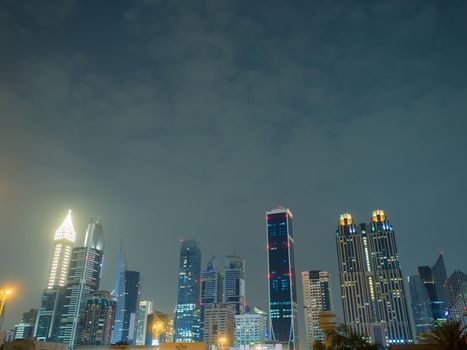 The streets of the night city and skyscrapers of Dubai. Timelapse