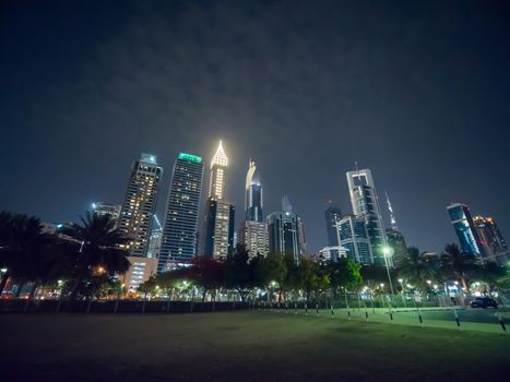 The streets of the night city and skyscrapers of Dubai. Timelapse