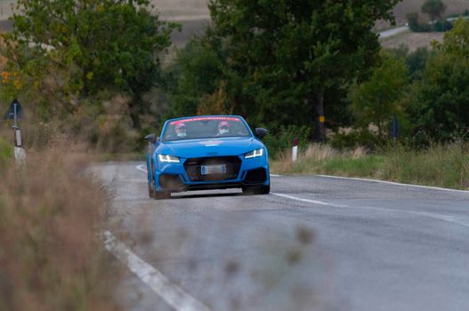 CAGLI , ITALY - OTT 24 - 2020 : audi tt roadster rs on an old racing car in rally Mille Miglia 2020 the famous italian historical race (1927-1957)