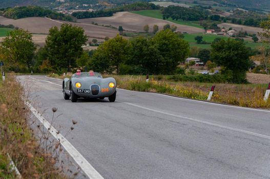 CAGLI , ITALY - OTT 24 - 2020 : JAGUAR C-TYPE 1952 on an old racing car in rally Mille Miglia 2020 the famous italian historical race (1927-1957