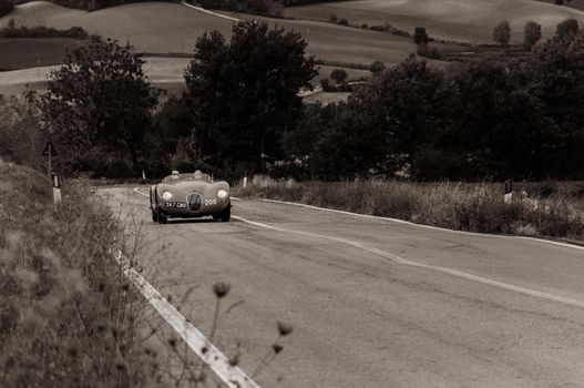 CAGLI , ITALY - OTT 24 - 2020 : JAGUAR C-TYPE 1952 on an old racing car in rally Mille Miglia 2020 the famous italian historical race (1927-1957