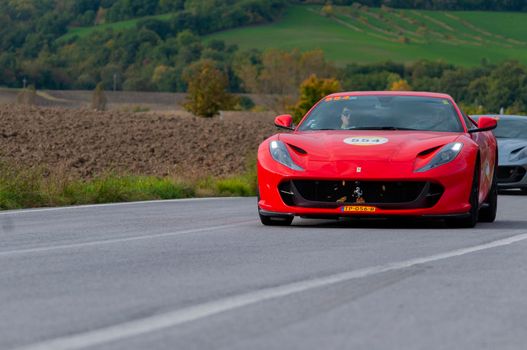 CAGLI , ITALY - OTT 24 - 2020 : Ferrari 812 SUPERFAST 2018 on an old racing car in rally Mille Miglia 2020 the famous italian historical race (1927-1957)