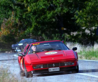 CAGLI , ITALY - OTT 24 - 2020 : FERRARI 328 GTS 1987 on an old racing car in rally Mille Miglia 2020 the famous italian historical race (1927-1957)