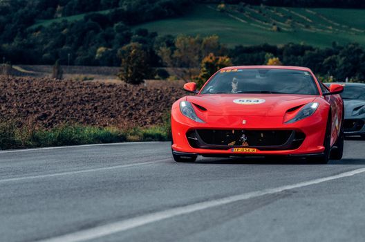 CAGLI , ITALY - OTT 24 - 2020 : Ferrari 812 SUPERFAST 2018 on an old racing car in rally Mille Miglia 2020 the famous italian historical race (1927-1957)