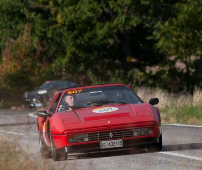 CAGLI , ITALY - OTT 24 - 2020 : FERRARI 328 GTS 1987 on an old racing car in rally Mille Miglia 2020 the famous italian historical race (1927-1957)