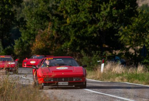 CAGLI , ITALY - OTT 24 - 2020 : FERRARI 328 GTS 1987 on an old racing car in rally Mille Miglia 2020 the famous italian historical race (1927-1957)