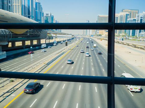 A wide multi-lane road in Dubai. View from the subway crossing