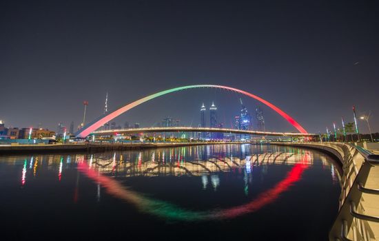 Panorama of night Dubai on the background of the bridge of the Dubai Greek canal