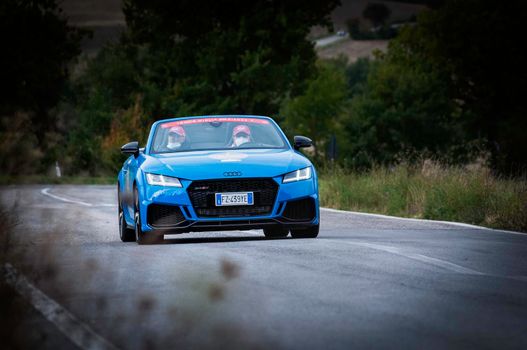 CAGLI , ITALY - OTT 24 - 2020 : audi tt roadster rs on an old racing car in rally Mille Miglia 2020 the famous italian historical race (1927-1957)