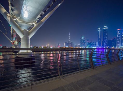 Panorama of night Dubai on the background of the bridge of the Dubai Greek canal