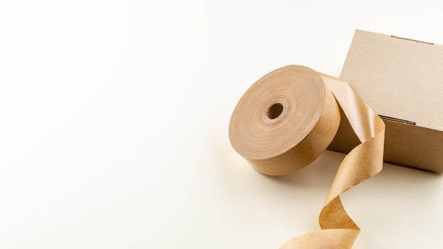 The roll of biodegradable sticky tape made of paper and cardboard box. Zero Waste Packaging Solution