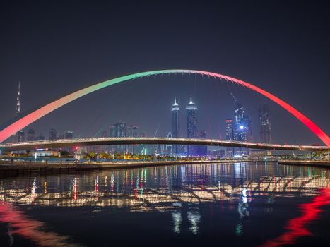 Panorama of night Dubai on the background of the bridge of the Dubai Greek canal