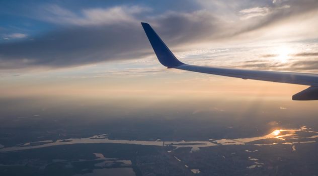 Sunset sky on airplane, plane window, over Kiev. Ukraine