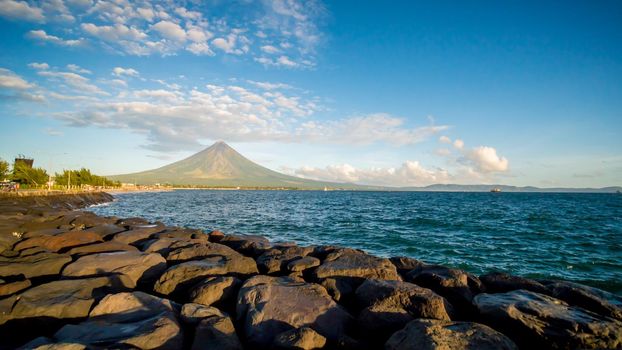 Legazpi City, Luzon, Philippines - Mount Mayon volcano looms over the city as daily life goes on