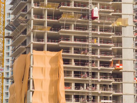 Construction of a multi-storey building in Dubai. Unfinished building facade close-up