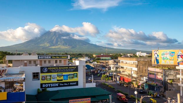 Legazpi City, Luzon, Philippines - Mount Mayon volcano looms over the city as daily life goes on.