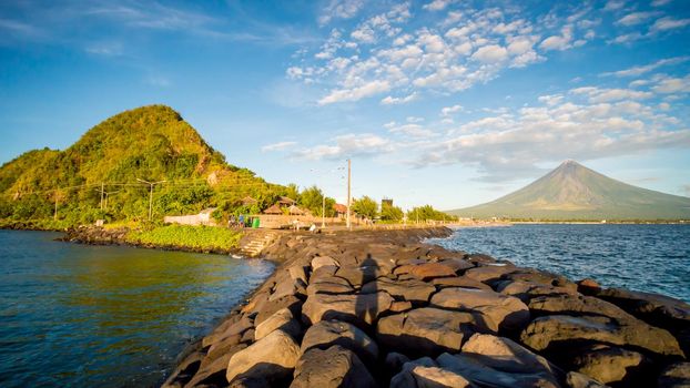 Legazpi City, Luzon, Philippines - Mount Mayon volcano looms over the city as daily life goes on