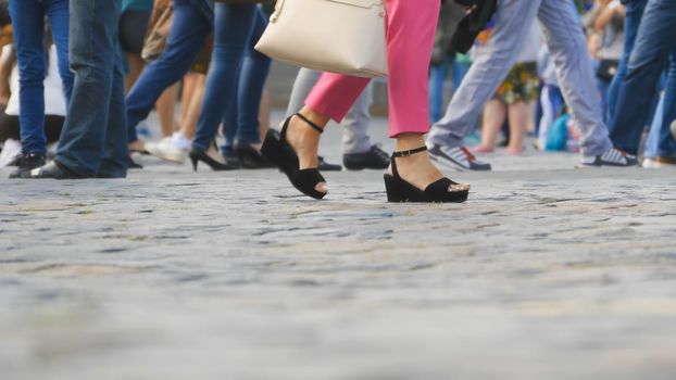 Legs of tourists on Red Square in Moscow.