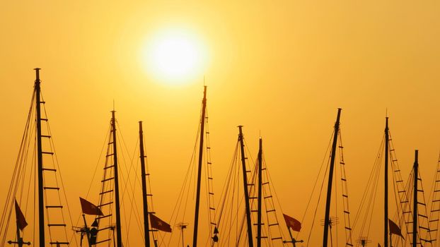 Masts of ships and boats at sunset. Vietnam