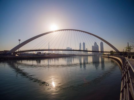 Panorama of the city early in the morning at dawn with a bridge over the city channel Dubai Greek