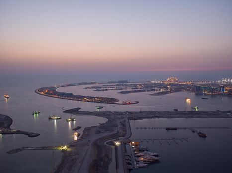 Sunset and night over the artificial islands of Dubai. Timelapse