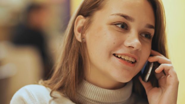 Cute young girl talking on a cell phone. Close-up