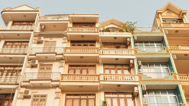 Houses built on the street where are placed back to back hostels and hotels. Air conditioners in the windows. Ha Long Bay City