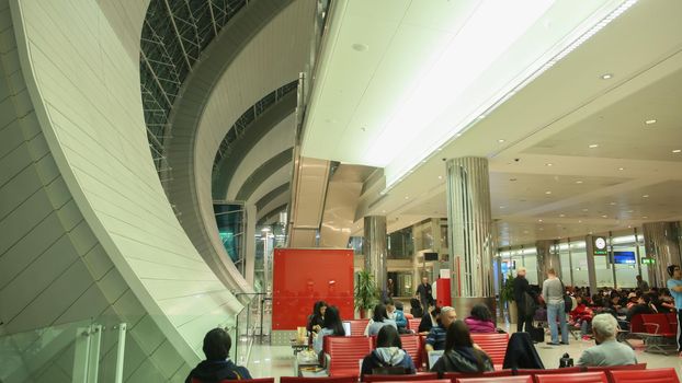 Modern interior inside the Hong Kong International Airport. Citizens and tourists of the city in the plane waiting room