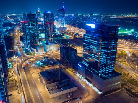 Panorama of the Dubai area with a road junction and traffic at night