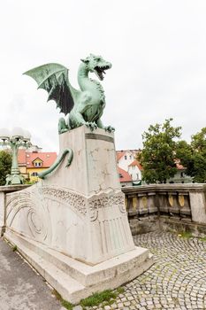 Sculpture of dragon on Dragon bridge on beautiful cloudy sky background in Ljubljana, Slovenia