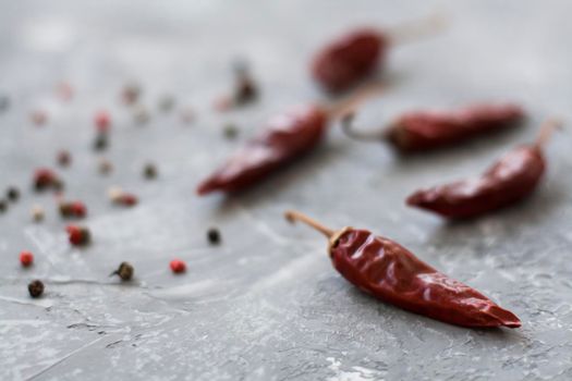 Red sharp dried dried chillies of pepper and pepper in grains on a vintage gray background