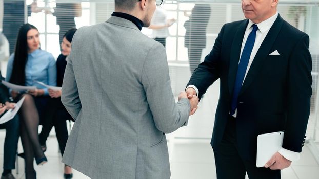businessmen shake hands standing in the conference room. concept of cooperation