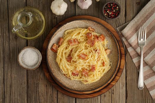 Carbonara pasta. Spaghetti with bacon, egg, parmesan cheese. Traditional italian cuisine. Top view
