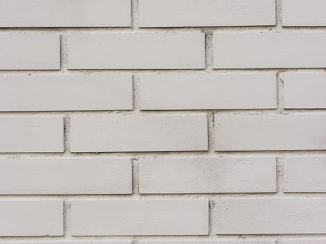 Abstract background of a gray brick wall close-up.