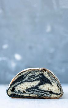 Isolated half of cuttlefish ink bread on blurry background