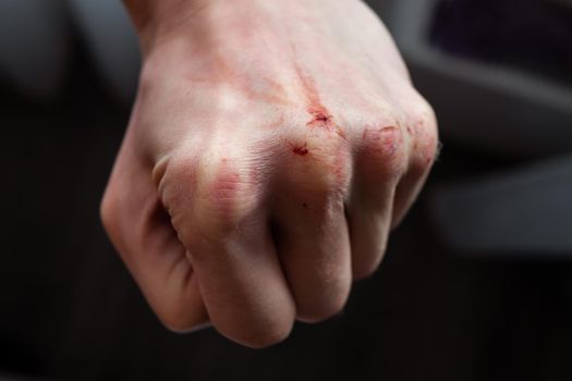 Close-up Of Human Hand Against Gray Background.