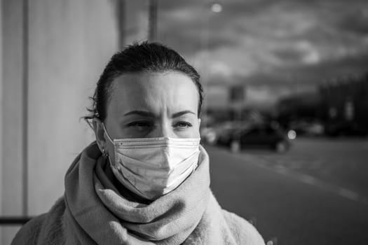 A picture of a girl in a mask. On the street. isolated Covid-19 pandemic.